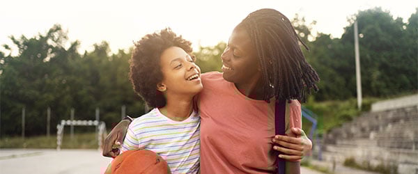 Parent and Guardian's Handbook Cover Image: mother and son at an outdoor basketball court