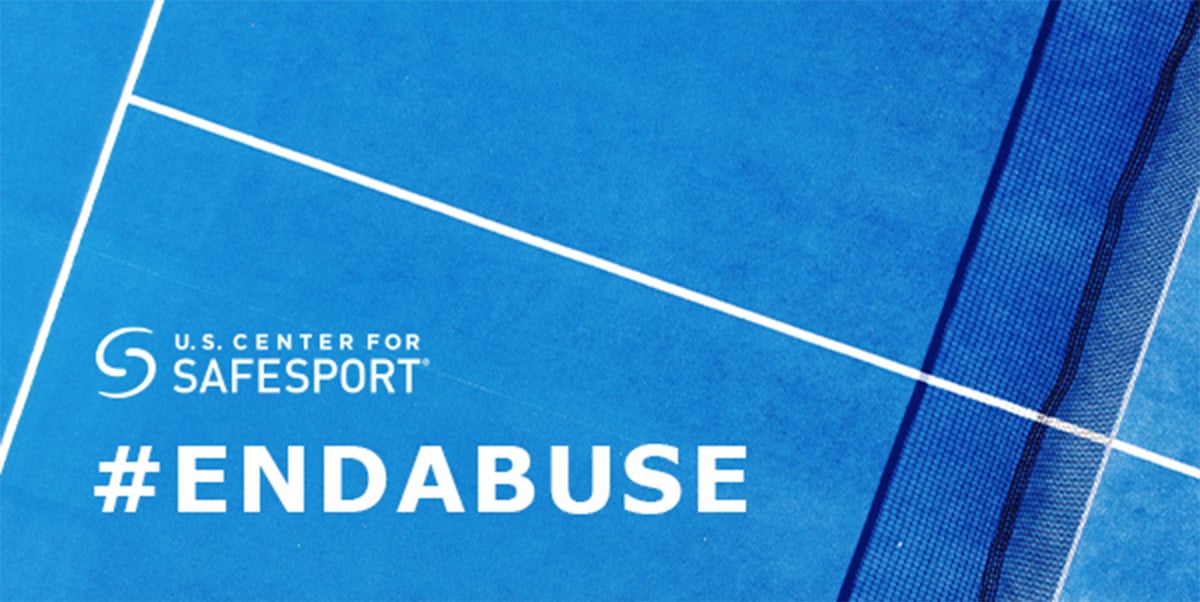 A bright blue tennis court, shot overhead with white lines and a net. #EndAbuse and U.S. Center for SafeSport logo embedded over court. 
